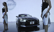 A model poses next to a Nissan GT-R during at the 42nd Bangkok International Motor Show 20...