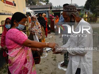 Voters uses hand sanitizer   during the first phase  during the first phase of  polling  for Assam Assembly Elections, at Rupohi   constitue... by Anuwar Hazarika/NurPhoto