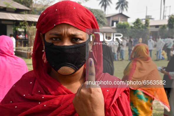 Woman voters hold up inked fingers after casting ballot  in the first  phase of polling for Assam Assembly Elections, at  Rupohi   constitue... by Anuwar Hazarika/NurPhoto