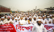 Activists of the Hefazat-e Islam, walk along a road during a demonstration in Dhaka on Mar...