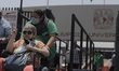 Older adults in wheelchairs leave the Olympic Stadium in Ciudad Universitaria, Mexico City...