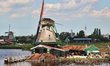 Windmills along a canal in the small town of Zaanse Schans, Holland, Netherlands, Europe. 