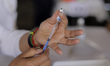 Medical personnel load syringes with the Sputnik V biological vaccine against COVID-19 to...