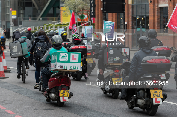 LONDON, UNITED KINGDOM - APRIL 07, 2021: Deliveroo couriers ride through the City of London during a strike action over pay, rights and work...