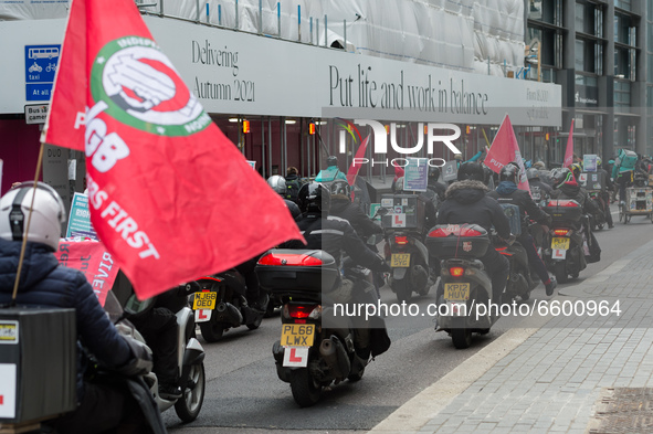 LONDON, UNITED KINGDOM - APRIL 07, 2021: Deliveroo couriers ride through the City of London during a strike action over pay, rights and work...