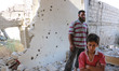 A man and his son inside the house destroyed
Targeting popular market district in the tow...