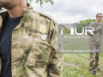 Volunteer with a medal of a battalion of the DPR army during a military training in the outskirts of Donetsk city on June 29, 2015. (