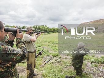 Soldiers shoot under the surveillance of a military  instructor of the DPR army in the outskirts of Donetsk city on June 29, 2015. (