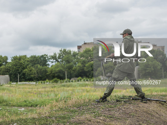Soldier shooting with a machine gun during a military training of the DPR army in the outskirts of Donetsk city on June 29, 2015. (