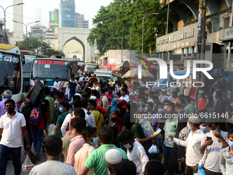 People waits at a bus stop for leave the city as Bangladesh authorities ordered an eight-day lockdown to contain the spread of the Covid-19...