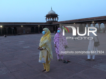 Women wearing mask click pictures of each other at the historic Jama Masjid on the eve of beginning of the holy month of Ramzan, in New Delh...