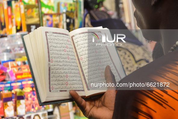 A Muslim man reads Quran on the second day of holy month of Ramadan at the Lagos Central Mosque (Lagos Island) located along the busy Nnamdi...