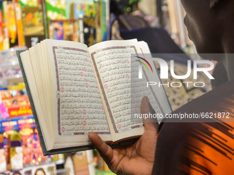 A Muslim man reads Quran on the second day of holy month of Ramadan at the Lagos Central Mosque (Lagos Island) located along the busy Nnamdi...