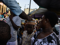 A Muslim boy shop for a traditional Nigerian cap at the entrance of the Lagos Central Mosque (Lagos Island) located along the busy Nnamdi Az...