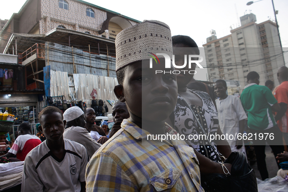 A Muslim pose for a portrait after shopping for a traditional Nigerian cap at the entrance of the Lagos Central Mosque (Lagos Island) locate...