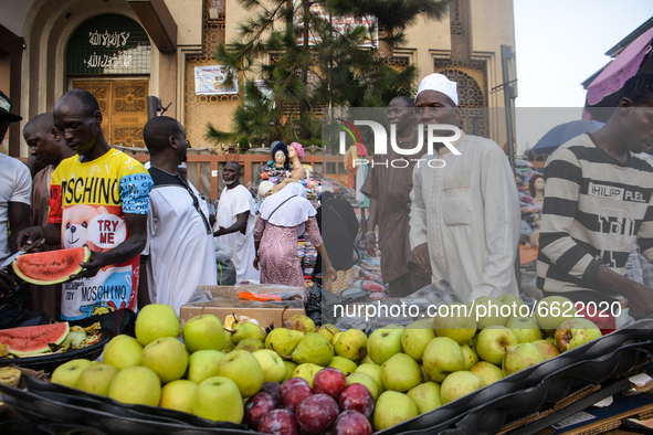 A street vendor sells watermelons/apple as he waits for customers at the entrance of the Lagos Central Mosque (Lagos Island) located along t...
