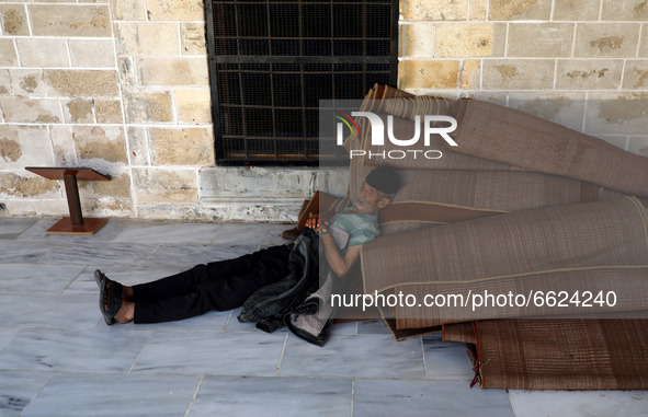 A Palestinian man rests before breakfast in Al-Omari mosque during the Muslim holy month of Ramadan, in Gaza City, on April 16, 2021.
 