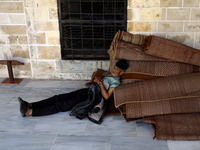 A Palestinian man rests before breakfast in Al-Omari mosque during the Muslim holy month of Ramadan, in Gaza City, on April 16, 2021.
 (