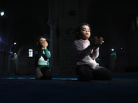  Palestinian children Pray in Al Omari mosque during the Muslim holy month of Ramadan, in Gaza City, on April 16, 2021.
 (