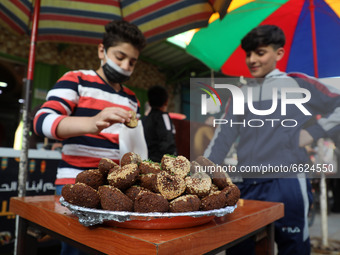 A Palestinian vender prepare Falafel during the Muslim fasting month of Ramadan in Gaza City on April 16, 2021, amid the COVID-19 pandemic....