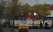 Police vehicles arrive at the scene of  Loyalists protest on Lanark Way, near the 'Peace G...