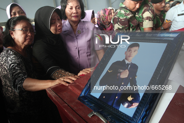 Family grief crying beside the body's coffin corpse military personnel, one of the victims of the collapse of the C-130 military aircraft du...