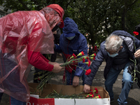 People lay red carnations during the commemoration of the 47th anniversary of the revolution of the Red Carnations in the city of Porto, Por...
