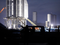 A security guard checks technicians credentials at the entrance to Starship SN15's launch pad on the evening on April 25th, 2021 at SpaceX's...