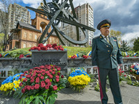 A Chernobyl liquidator poses in a memorial site about the Chernobyl catastrophe during the celebrations in Kiev, Ukraine, on April 26, 2021...