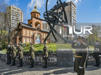 Soldiers show their respects in the memorial site about the Chernobyl catastrophe during the celebrations in Kiev, Ukraine, on April 26, 202...