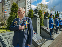 A Chernobyl liquidator shows his respects in the memorial site about the Chernobyl catastrophe during the celebrations in Kiev, Ukraine, on...