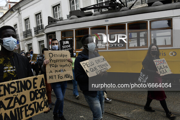 Students wearing protective masks and holding placards alluding to the university crisis march through the different streets of Lisbon. Apri...