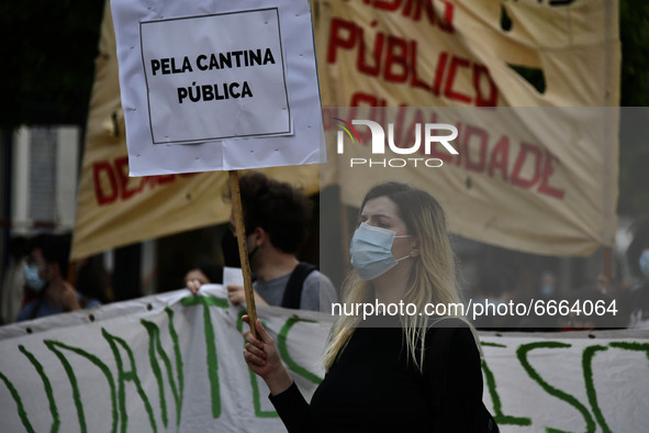 Students wearing protective masks and holding placards alluding to the university crisis march through the different streets of Lisbon. Apri...