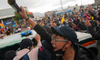Demonstrators vandalize an occupied police patrol unit in Bogota, Colombia on April 28, 20...
