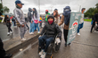 A demonstrator in a wheelchair is scorted outside riots in Bogota, Colombia on April 28, 2...