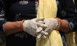 A family member offers prayers next to the coffin of a person, who died of the coronavirus...