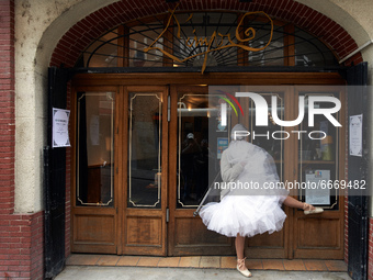 An actress plays in front of closed restaurant entrance. Disguised culture workers (actors, live artists, dancers, musicians, technicians, e...
