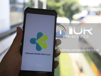 A Man use his a mobile phone, using eHAC Indonesia app at the Bus station in Bogor, Indonesia, on May 01, 2021. The Indonesian government ob...