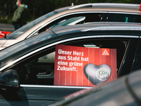 placard of " out heart and steel have green future" is seen during the drive in labor day rally in Duesseldorf, Germany on May 1, 2021 (