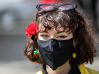 A women wearing mask with a red carnation during the International Worker's Day, on May 1, in Lisbon, Portugal.
International Worker's Day...