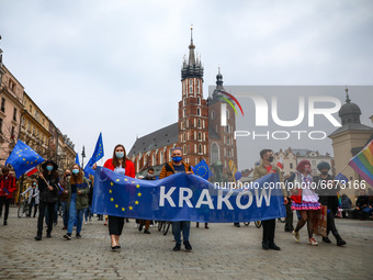 People walk through the Main Square during celebration of 17-year of Polish membership in the European Union. Krakow, Poland on May 1st, 202...