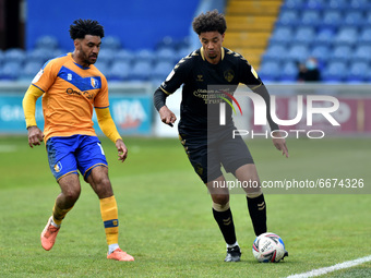 Oldham Athletic's Cameron Borthwick-Jackson tussles with Jamie Reid of Mansfield Town during the Sky Bet League 2 match between Mansfield To...