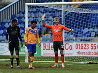 Oldham Athletic's Laurie Walker (Goalkeeper) and Oldham Athletic's Kyle Jameson with Jamie Reid of Mansfield Town during the Sky Bet League...