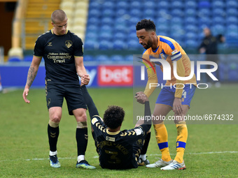 Oldham Athletic's Harry Clarke, Oldham Athletic's Cameron Borthwick-Jackson and Jaden Charles of Mansfield Town during the Sky Bet League 2...