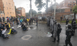 People protesting sit in front of agents of the mobile anti-riot squad in Bogota, Colombia...