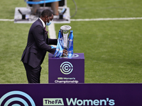  Emile Heskey places the womens Championship trophy on the stand after the FA Women's Championship match between Leicester City and Charlton...