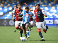 Luca Ceppitelli of Cagliari Calcio competes for the ball with Lorenzo Insigne of SSC Napoli during the Serie A match between SSC Napoli and...