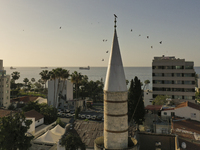 The crow sits on the minaret of the Grand Mosque of Limassol overlooking the Mediterranean coast. Limassol, Cyprus, Wednesday, May 5, 2021....