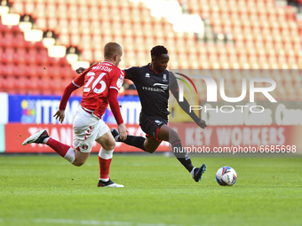  Tayo Edun of Lincoln City battles for possession with Ben Watson of Charlton Athletic during the Sky Bet League 1 match between Charlton At...