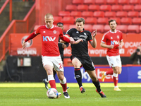  Ben Watson of Charlton Athletic battles for possession with James Jones of Lincoln City during the Sky Bet League 1 match between Charlton...